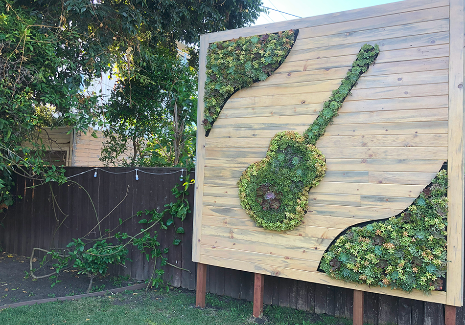 Outdoor privacy living wall with guitar design